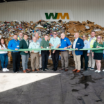 Employees of WM pose at new facility.