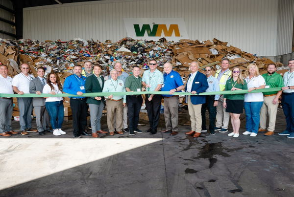 Employees of WM pose at new facility.