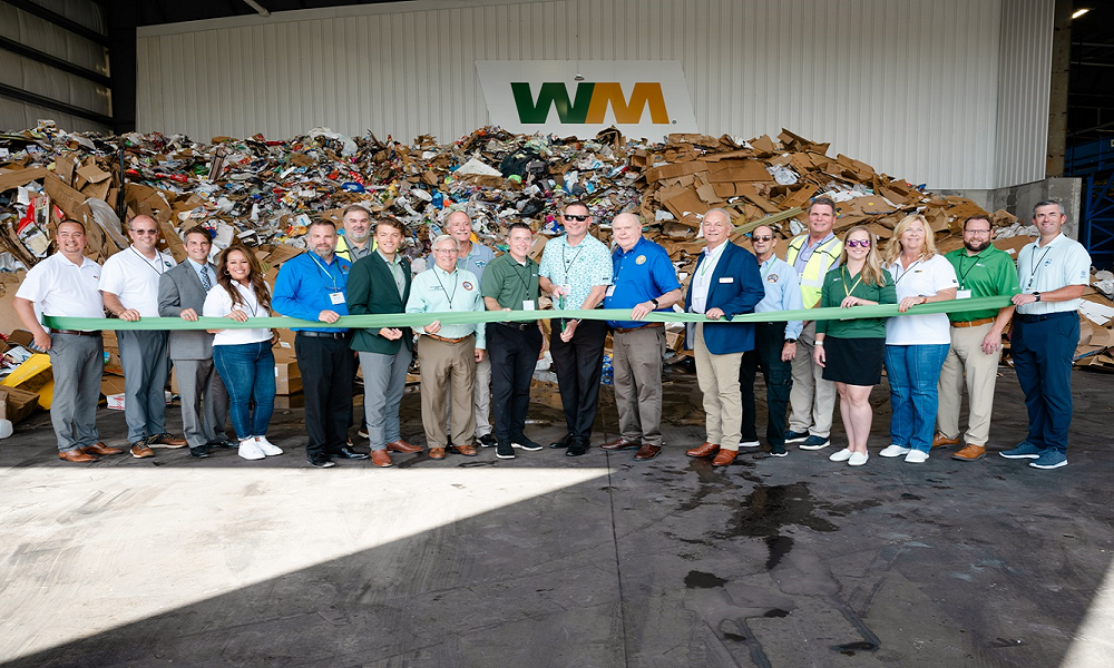 Employees of WM pose at new facility.