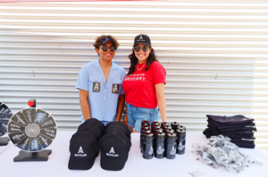 two employees standing in front of activities