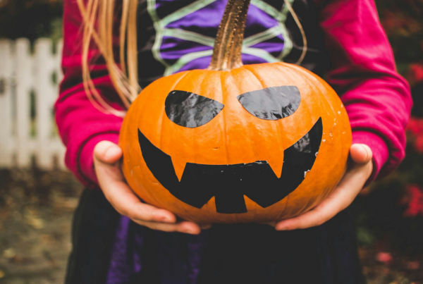 girl holding jack-o-lantern