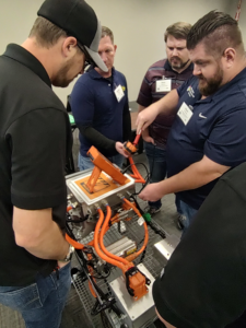 attendees participate in EV battery training