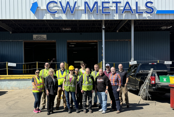 group standing in front of recycling company