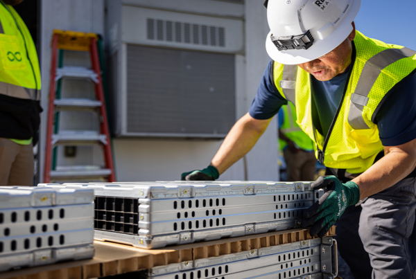 man in hard hat working with batteries