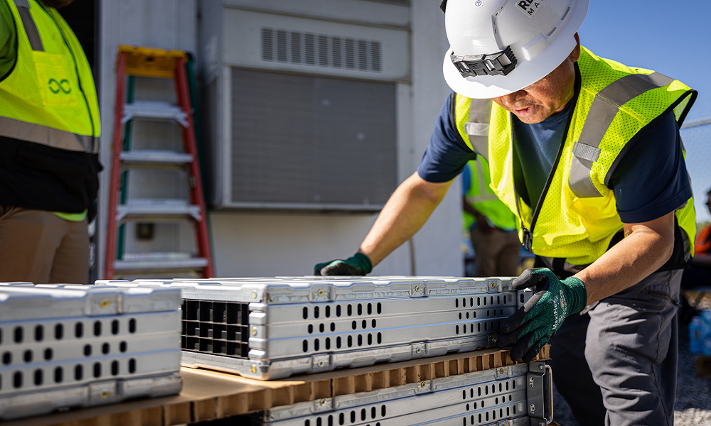 man in hard hat working with batteries