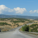 truck on the road with mountains in background